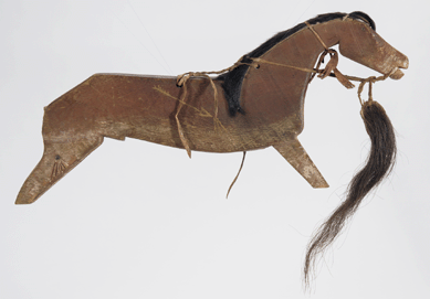 Around 1860, the famous warrior and diplomat Medicine Bear carved this likeness in memory of his war pony, killed in battle in northern Montana. Made of wood and pigment, the mane and tail on this dance stick came from that honored horse. 