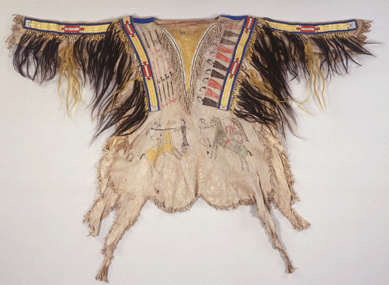 Belonging to the Northern Tsitsistas/Suhtai (Cheyenne) tribe, this shirt was made around 1865 of hide, porcupine quills, glass pony beads, human hair, horsehair, sinew and tree pitch/gum and paint. The pipe images indicate the number of war parties led by its owner; the human figures on the right represent defeated enemies who are depicted without legs and will never move again.