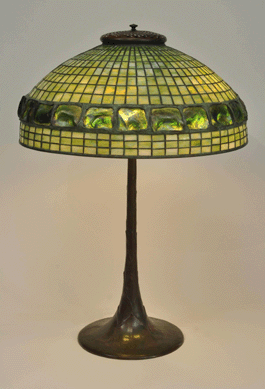 A Tiffany Studios Turtleback tile Favrile glass and patinated bronze geometric table lamp, first quarter Twentieth Century, 28 inches high, diameter 20 inches, realized $27,500.