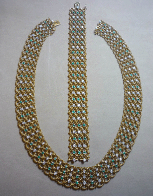 An emerald and diamond necklace and matching bracelet set in 18K yellow gold brought $23,600.