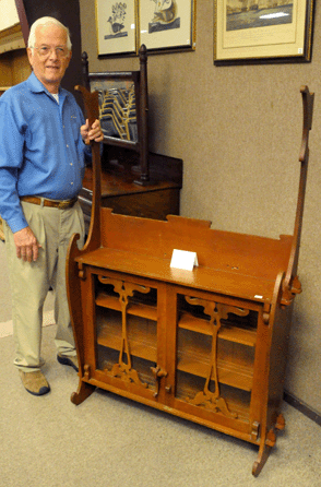 Found in a barn, a signed and dated hanging cabinet by Arts and Crafts cabinetmaker Charles Rohlfs, atypically constructed from cherry, sold at only $4,255. 