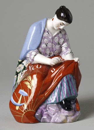 Natalia Danko (Russian, 1892‱942), figurine, woman sewing banner, 1920, glazed porcelain, 5¾ by 3½ inches. The Wolfsonian-Florida International University, Miami Beach, Fla. 