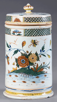 This container likely was used for toiletries, tobacco or snuff and was made circa 1730‱740 at the Guilibaud manufactory in Rouen. The fleurs des Indes ornamentation seen here is in imitation of the Chinese famille verte porcelain. After years of "camaieu bleu†being in vogue, polychrome decoration in France made a comeback around 1720‱730. ₩Susan Einstein photo