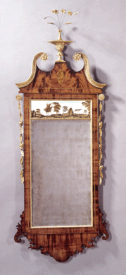 A $31,200 bid, against a high estimate of $12,000, took this Federal mahogany inlaid and parcel-gilt eglomise mirror, New York, circa 1800, with flowering gilt vines flanking the eglomise panel showing a village, 68½ inches high and 26½ inches wide.