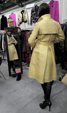 A young lady checks a jacket for fit and style at Marlene Wetherell Vintage Fashions, New York City.