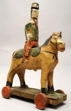 A mid-Atlantic carved and painted cavalry soldier on wheels, circa 1820‱850, would have high appeal for militia-mad little boys of the era.