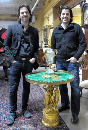 The Millea Brothers, Michael, left, and Mark with one of the star lots of the auction, an Empire bonze, malachite gueridon signed Thomire that sold for $20,400.