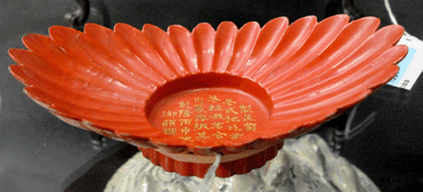The rare red lacquer scalloped dish with inscribed Imperial poem sold at $18,000.