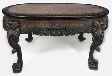 A Nineteenth Century Chinese hardwood center table inset with a rouge marble top was carved finely and sold for $25,740.