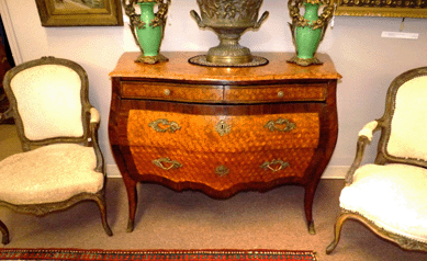 An Eighteenth Century Italian rococo bombe form commode brought $17,550.