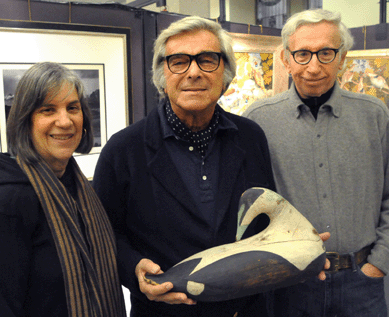 Susan and Sy Rappaport flank folk art collector Jerry Lauren with his newly purchased eider drake by Gus Wilson.