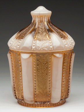 The Greentown No. 450 / Holly Amber covered sugar bowl realized $3,335 over estimates of $300/400. It was executed in golden agate color by the Indiana Tumbler & Goblet Co., circa 1903, 6 5/8 inches high.