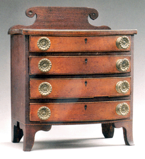 Auctioneer Ron Bourgeault kept the momentum up until the very end. Sunday’s closing lot was this Massachusetts miniature Hepplewhite veneered bow front chest of drawers. Only 11 ½ inches tall and in untouched original condition, the tiny case piece garnered $48,720.