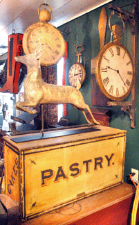 The "pastry” box in bright yellow paint was $5,462, while the stag weathervane realized $28,750.