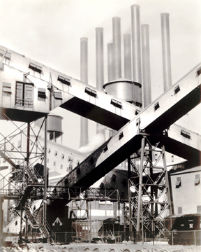 Sheeler's photograph, "Criss-Crossed Conveyors, River Rouge Plant, Ford Motor Company,” 1927, suggests the aesthetic appeal he found in crisp, linear elements of the huge industrial complex. Lent by The Metropolitan Museum of Art.