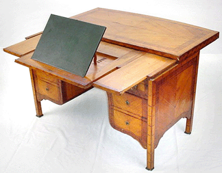 An interesting Continental marquetry desk had foldout surfaces for writing and reading and interior compartments and realized $4,950.