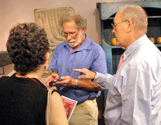 Steve Corrigan, right, helps clients during the opening moments of the show.