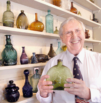 Norman Heckler with the rare concentric ring eagle flask in a brilliant medium green color with an unusual amber mouth.