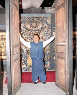 Shoreham, N.Y., dealer Vichai Chinalai invites visitors to step through a pair of Chinese carved wood gates to inspect his collection of Long Bei ceremonial dragon covers.