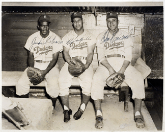 Photograph of Jackie Robinson, Roy Campanella and Don Newcomb in the Dodgers dugout, circa 1958‶0, signed by all three, which sold for $3,840.
