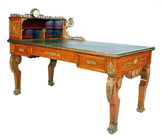 The late Nineteenth Century French Empire-style satinwood bureau plat with ornate gilt mounts and an end-mounted cartonnier sold for $15,400. 
