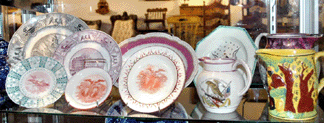 William and Theresa F. Kurau, Lampeter, Penn., displayed a large selection of Anglo American ceramics, including the Washington and Lafayette plate by Enoch Wood & Sons, circa 1824′8, shown just to the left of the 1812 Free Trade and Sailors' Rights jug with eagle and flag. The scarce plate has a polychromed enamel border and orange transfer.