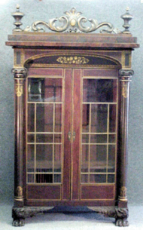 The Nineteenth Century New York bookcase with gilt stenciling and carving was unsigned, but the general agreement was that it was a Meeks piece. It went to the trade for $27,600.