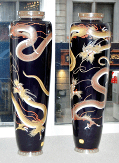 The 24-inch pair of Japanese Meiji cloisonné vases decorated with a wraparound design of dragons in brown and greenish yellow against a black body sold on the phone for $49,938.
