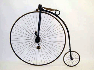 Two early bicycles (one shown) with a very large front wheel and a small rear wheel each sold for $3,450.
