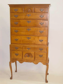 A New England Queen Anne highboy in maple with fan carvings and cabriole legs and pad feet, signed C.H. Seavey, Portsmouth, N.H., realized $3,220.