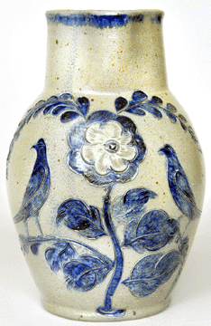 A one-gallon stoneware pitcher, 11 inches tall, with elaborate bird and floral incised decoration, crossed the block at $69,000.