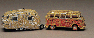 In "Deluxe Samba Pulling Bambi,†2005, Carol Sarkasian applied rhinestones, glass beads, gold leaf and silver leaf to a model car and trailer, transforming them into glittering, eye-popping objects. Responding to her interest in travel and tourism, she elevates tourism and popular culture to a high level, undermining distinctions between jewelry and sculpture.