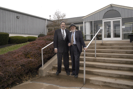 Sandy and Sanford Alderfer stand in front of their auction center, which last year celebrated its 20th anniversary in this location.