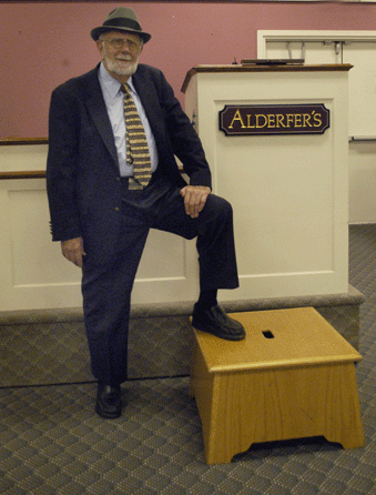 Sanford, shown inside the auction gallery, is well known for his hats and his auctioneering box. While the box's construction is simple, it has ably served its purpose, as well as adding a level of showmanship. It is also a metaphor for the man who has enjoyed living a "simple life†and stayed true to his Christian values, making sure to treat customers in his business fairly and ethically.