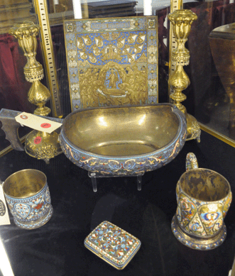 A small collection of Russian enamel pieces attracted international attention with the kovsh, center, selling at $31,625. The tea glass holder, right, brought $15,525 against an estimate of $2/3,000.