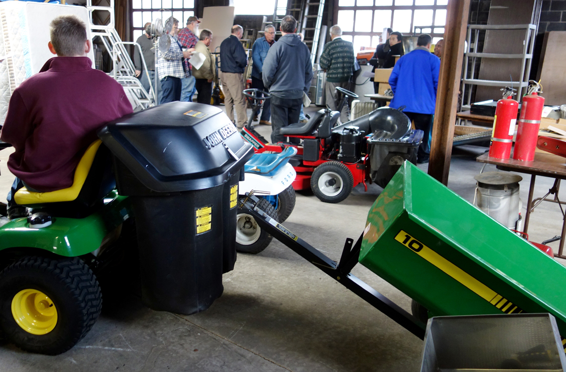 Equipment for lifting, storing, displaying, packing or selling all kinds of objects filled a major portion of the storage-garage space at the rear of the building and made for an interesting part one of the auction. Five mowing machines, including the John Deere tractor ($ 2,070), were sold at the start of second session of the sale.