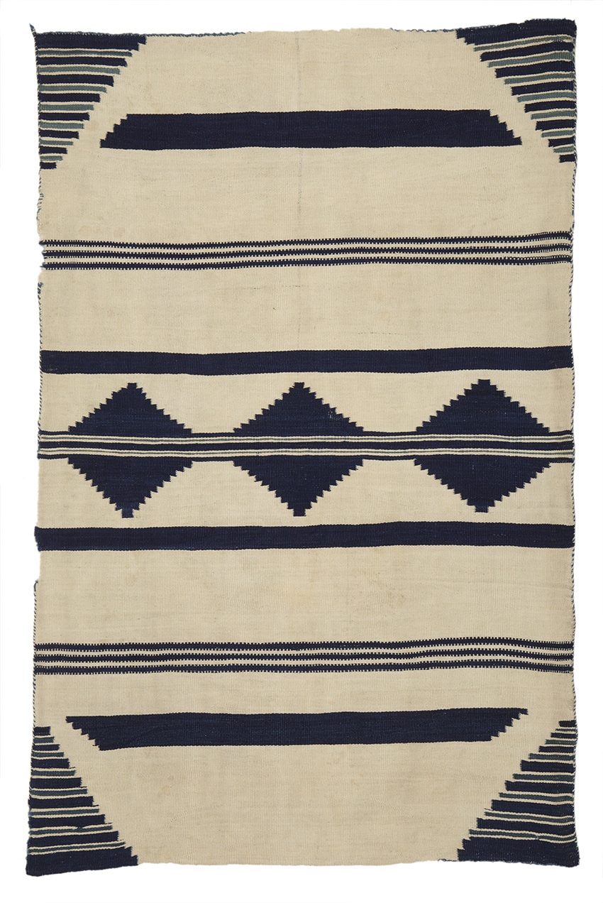 Serape-style blanket, Diné (Navajo), 1800–1860; weft-faced plain weave or tapestry weave, handspun Churro wool warp, handspun Churro wool weft in natural white, indigo-dyed blue, and indigo-dyed blue combined with vegetal yellow to produce green. Durango Collection, Center of Southwest Studies, Fort Lewis College, Durango, Colo.