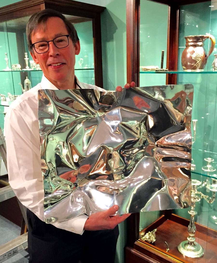 Jim McConnaughy, senior vice president at S.J. Shrubsole, Inc,<br>holds a 1989 silver fruit dish by Verner Panton of Denmark.