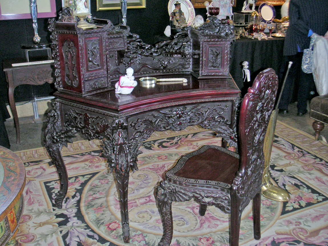 This rosewood pierce-carved Chinese desk and chair from the first quarter of the Twentieth Century was the highlight of White Orchid Antiques, Bordentown, Penn. The elaborate piece was made in a crescent shape form and carved front and back with exotic dragons and other Asian mythological symbols.