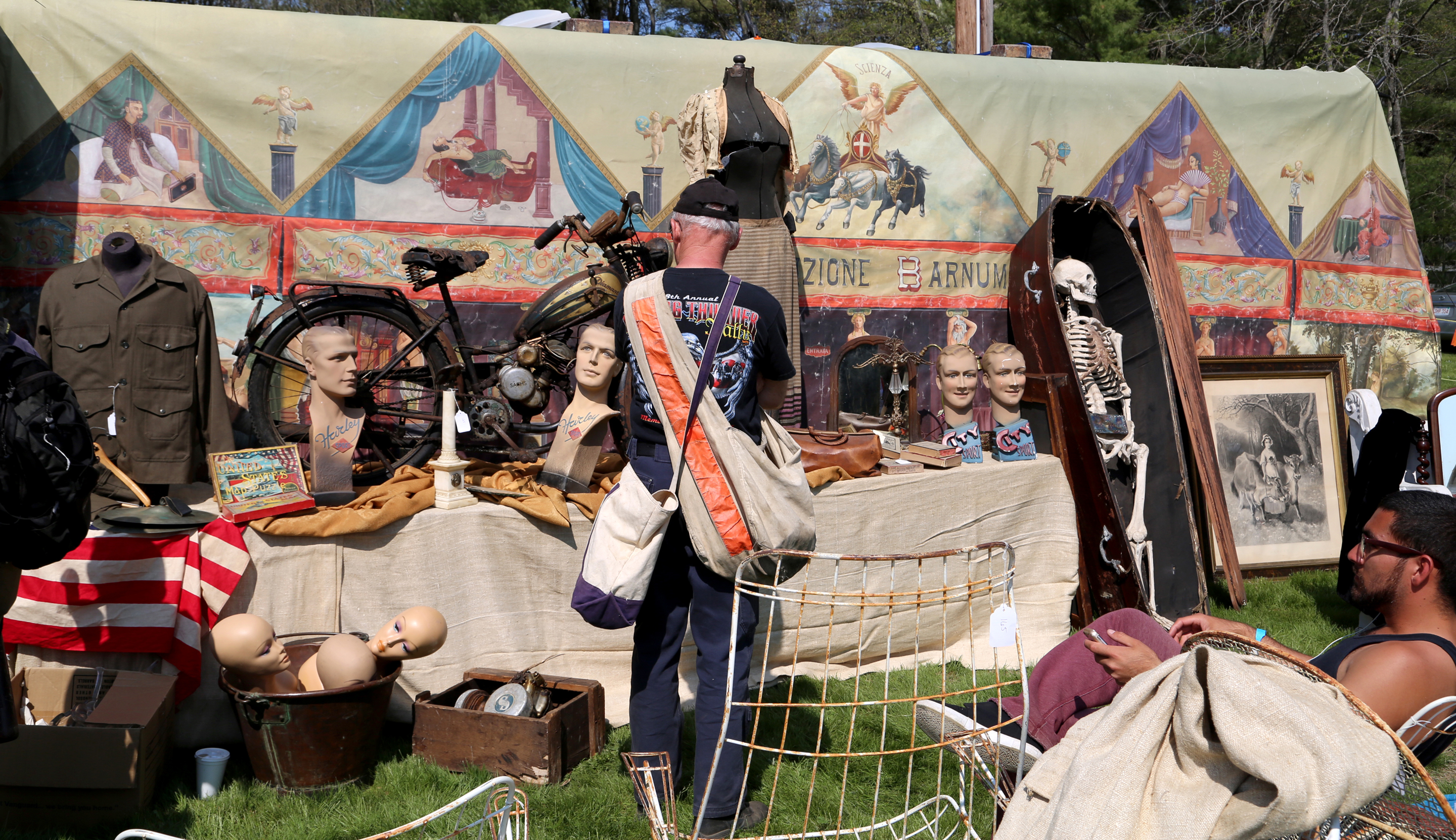 A booth of curiosities featuring a Diamant motorcycle, mannequin heads<br>and an Italian backdrop with religious scenes were brought by Kevin Harper, Round Top, Texas. —May’s