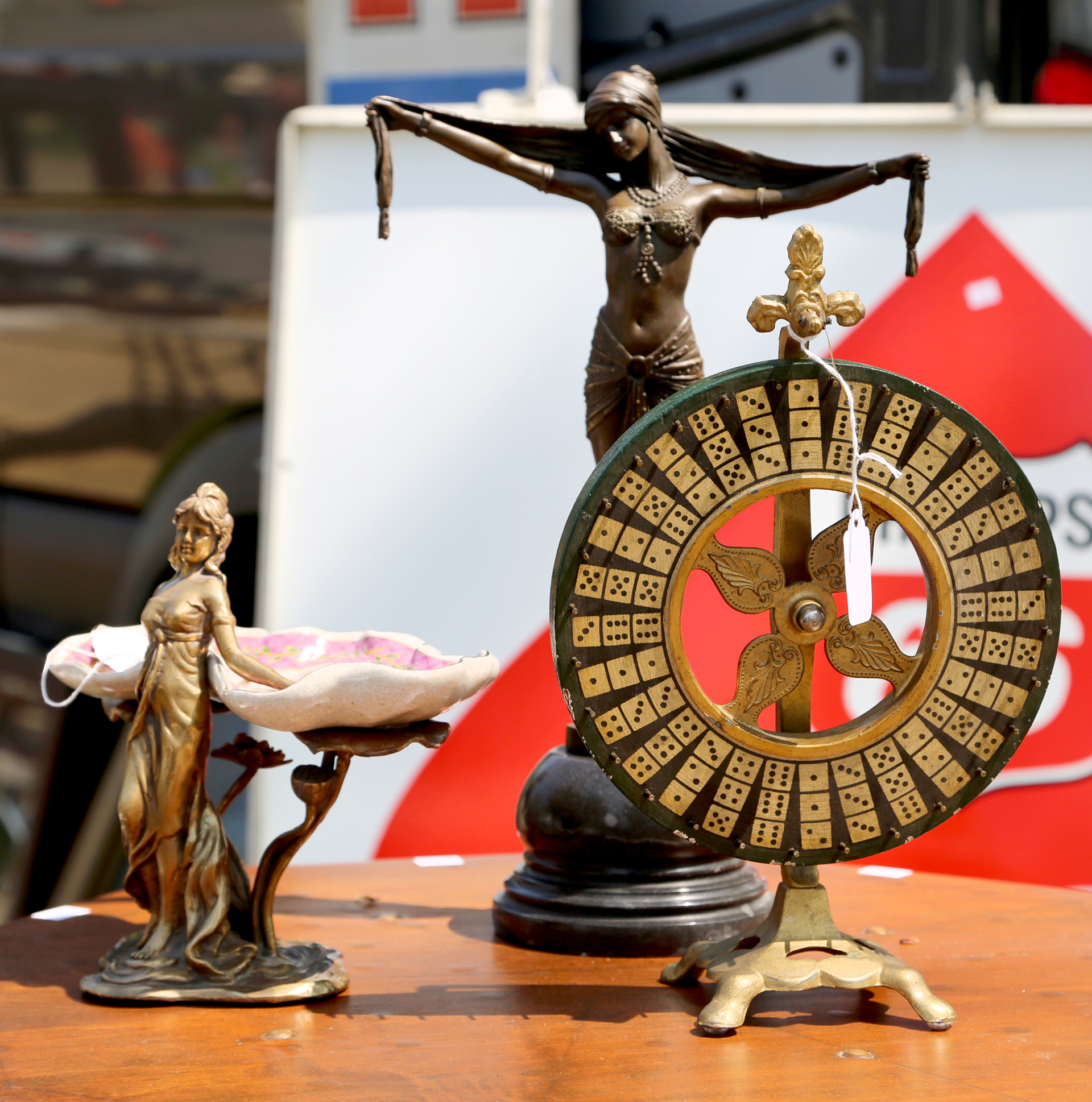 Expo Auction, Akron, Ohio, showed off a salesman’s sample game wheel<br>amid antique bronzes, including one by D.H. Chiparus. —May’s