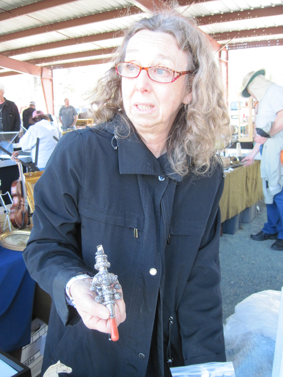 Holly Kahn, Brookline, Mass., was showing an early sterling baby rattle.<br>—Dealers Choice