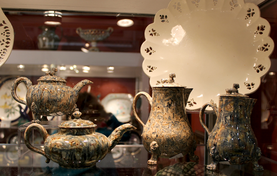 A rare agateware grouping — teapots, milk jug and covers — with foo dog handles, circa 1750, at Maria & Peter Warren Antiques, Sandy Hook, Conn.