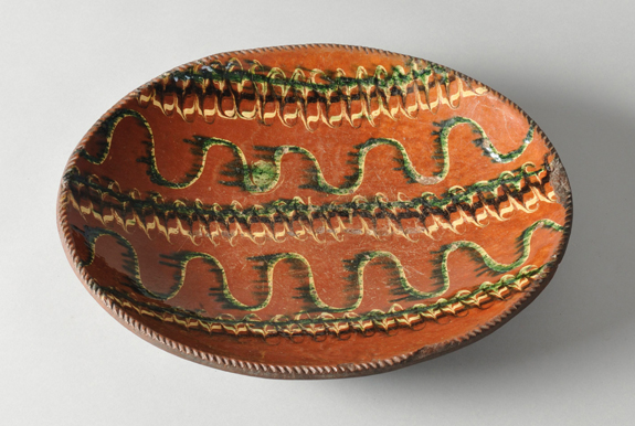 Attributed to Hoyt Pottery of Norwalk, Conn., this 14-inch-wide redware plate with vivid yellow, green and manganese slip decoration claimed $ 8,000 from an internet bidder. The ceramic hung above New Hampshire auctioneer Dick Withington’s kitchen sink before Stephen-Douglas Antiques acquired it and sold it to Scranton.