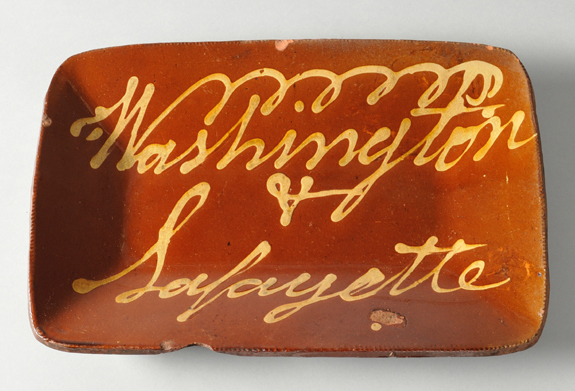 Inscribed “Washington & Lafayette” in yellow slip, this 10¼-by-15½-inch loaf dish was, at $ 13,000, the sale’s most costly piece of redware. It is thought to have been made in Norwalk, Conn., in the early Nineteenth Century.