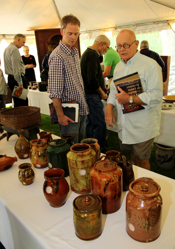 Pottery enthusiasts Justin Thomas of Newburyport, Mass., and David Good of Camden, Ohio, check out redware vases, many lusciously glazed.<br>Both men bid aggressively.