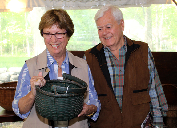 New Hampshire dealers Gail and Don Piatt admired a small green painted woven splint-handle basket. The late Nineteenth Century example brought $ 1,700.