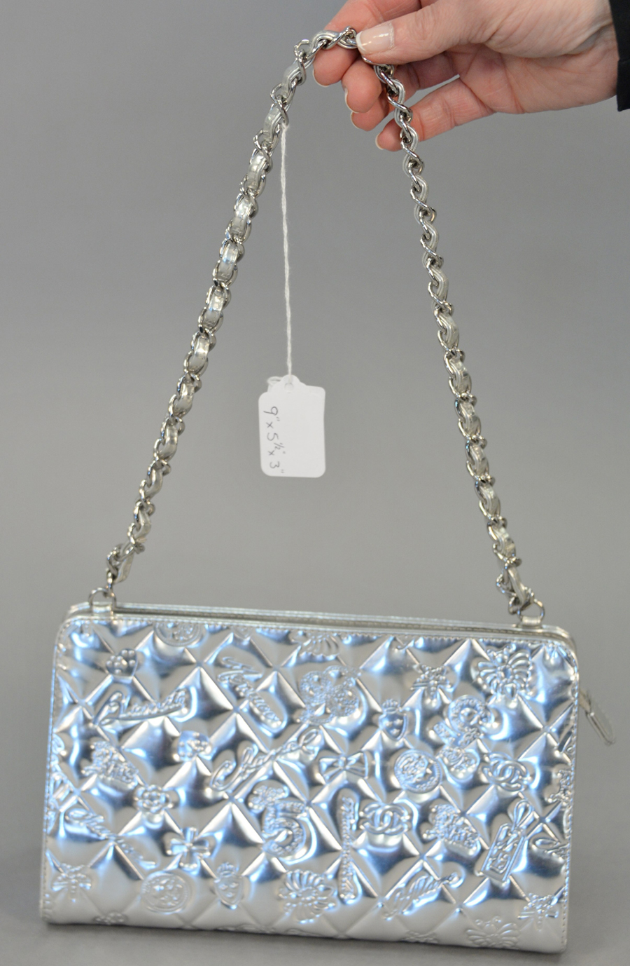 A Chanel quilted metallic silver leather handbag/purse, special edition marked Biarritz, Monaco Paris, Mademoiselle. 9 by 5½ by 3 inches, <br> also did well at $ 2,160.