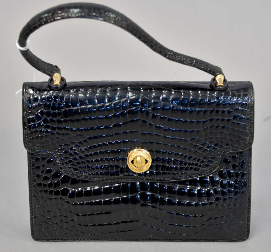A vintage Gucci black pressed alligator leather handbag/purse, 6½ by 10½ by 2 inches, quadrupled its high estimate to attain $ 1,625.