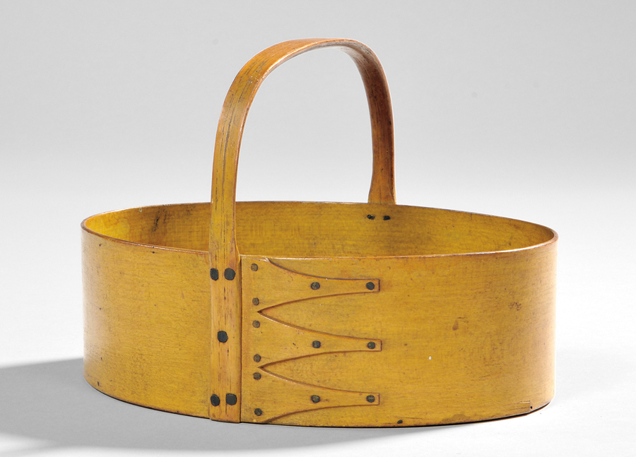 “MY,” an abbreviation for ministry, is inscribed in black ink or paint on the<br>back side of this yellow painted oval fixed-handle carrier, Canterbury, N.H.,<br>Nineteenth Century, $ 14,760 ($ 15/25,000). Collection of Erhart Muller.